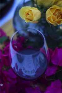 Red wine and yellow roses with bougainvillea